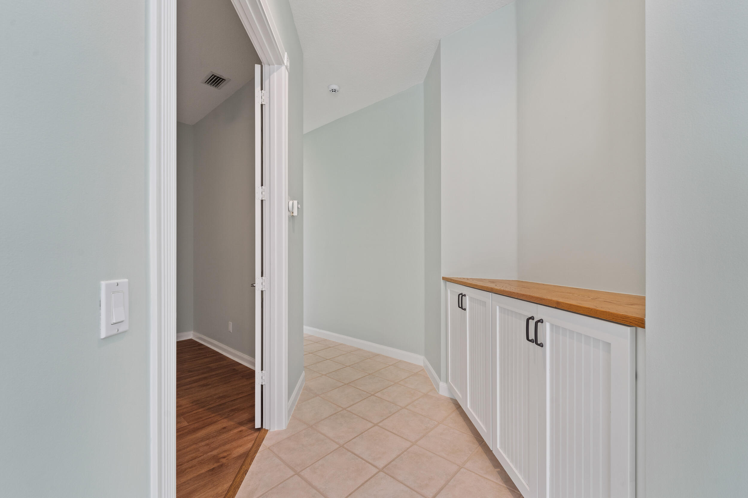 7945 Southeast Paurotis Lane Hobe Sound, FL 33455 - Photo 34 of 64 a view of a hallway with wooden floor and entryway