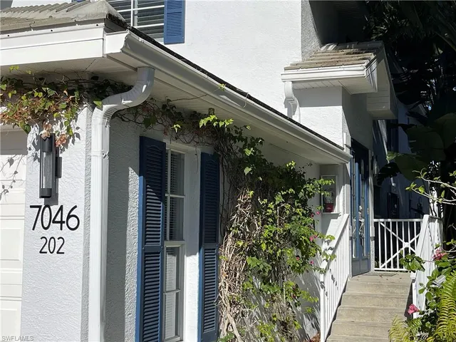 a view of a house with a flower garden