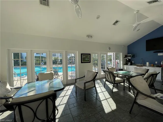 a living room with furniture and a floor to ceiling window