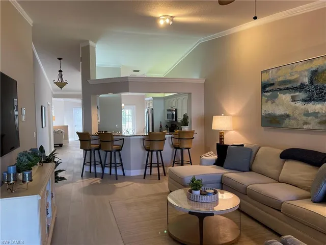 a living room with furniture potted plant and a window