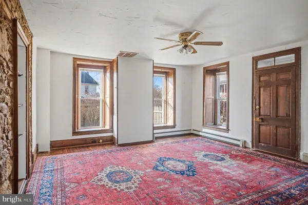 a view of a livingroom with a ceiling fan and window