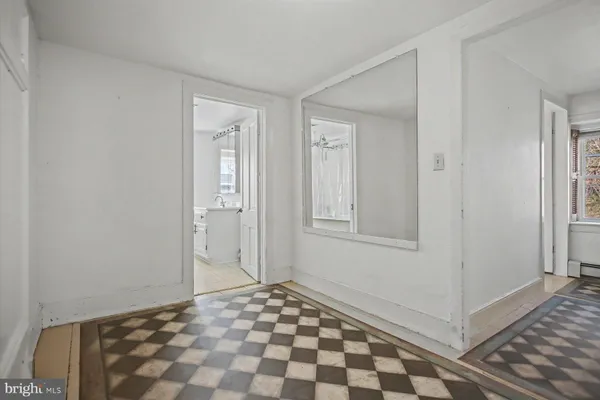 a view of a closet area with wooden floor
