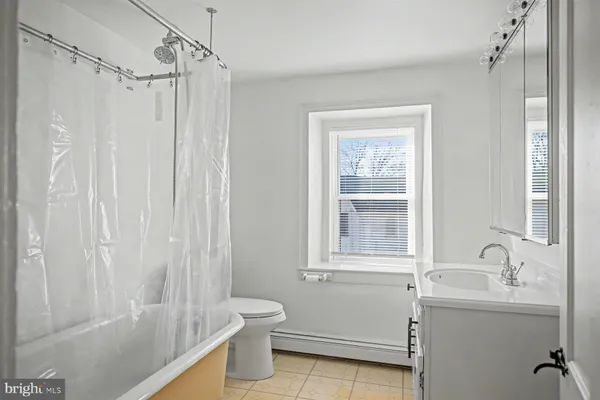 a bathroom with a granite countertop bathtub shower and sink