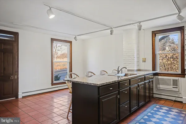 a kitchen with a refrigerator sink and cabinets