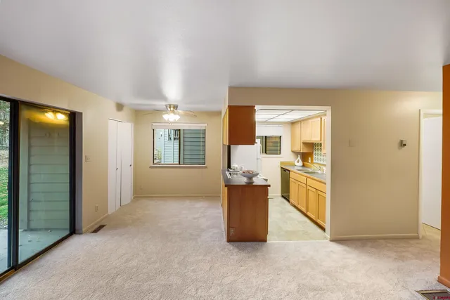 an empty room with cabinet and mirrors