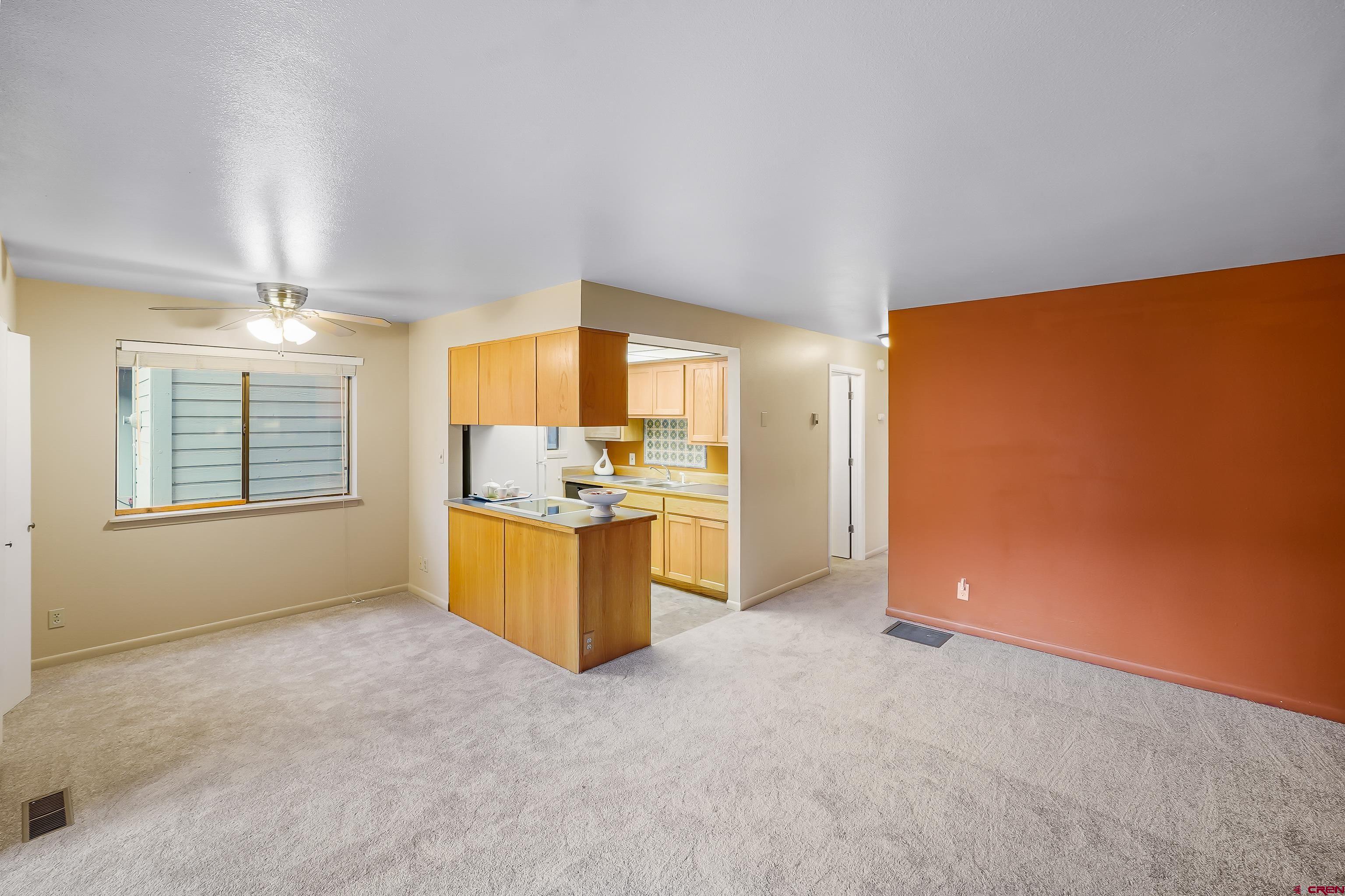 1200 Florida Road, Unit 7 Durango, CO 81301 - Photo 9 of 26 an empty room with a kitchen view and a window
