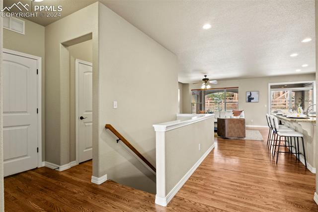 2464 Cinnabar Road Colorado Springs, CO 80921 - Photo 20 of 43 Hall featuring hardwood / wood-style floors and a textured ceiling