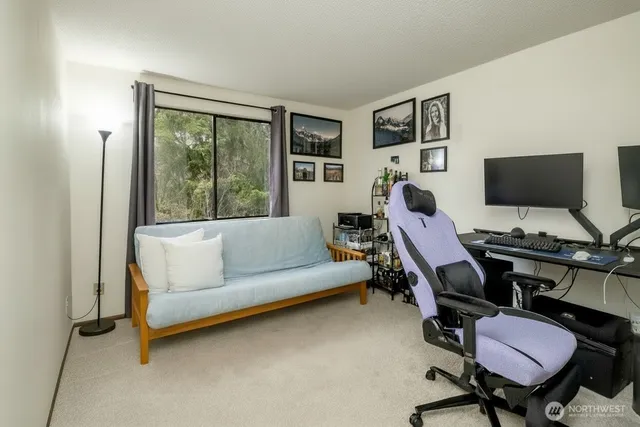 a view of a workspace with furniture and a ceiling fan