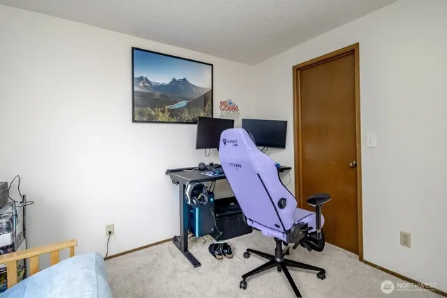 a bedroom with bed and a potted plant
