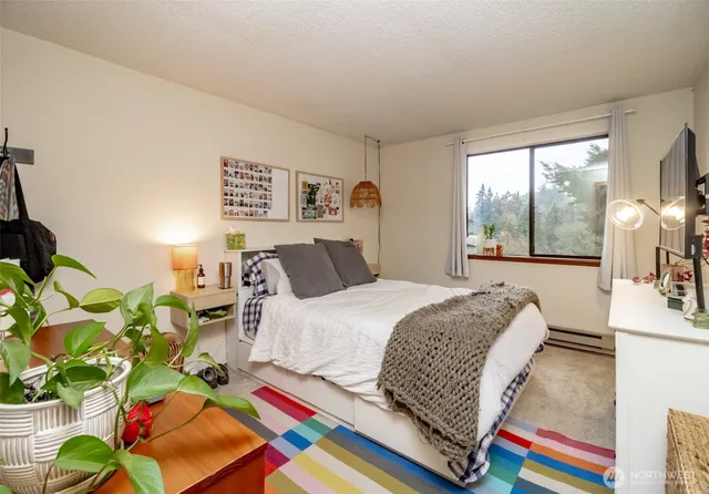 a bed sitting in a bedroom and a lamp