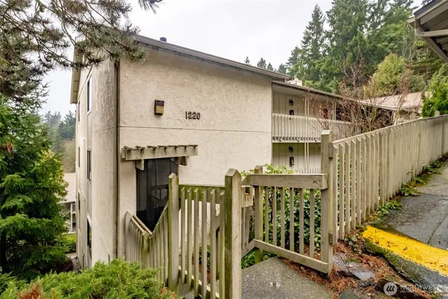 a front view of house along with trees