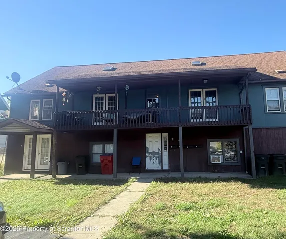 a view of a house with large windows