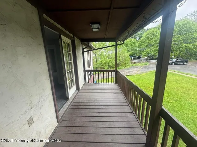 a view of a balcony with wooden floor
