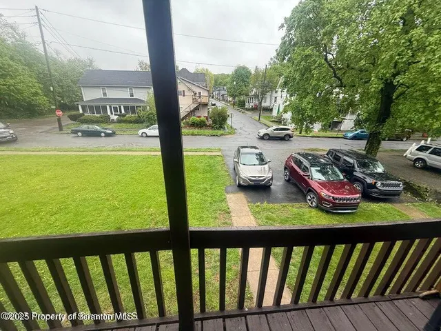 a view of a porch with furniture and garden