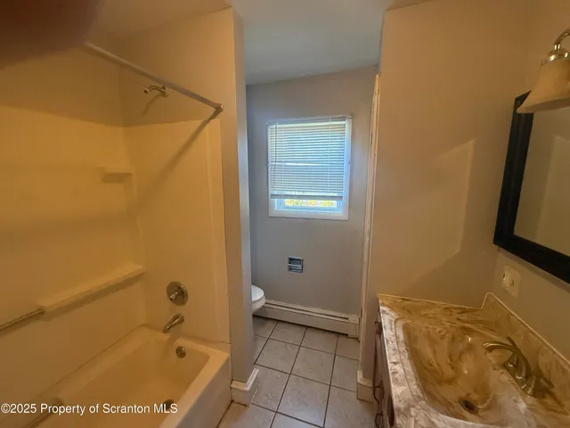 a bathroom with a tub and sink