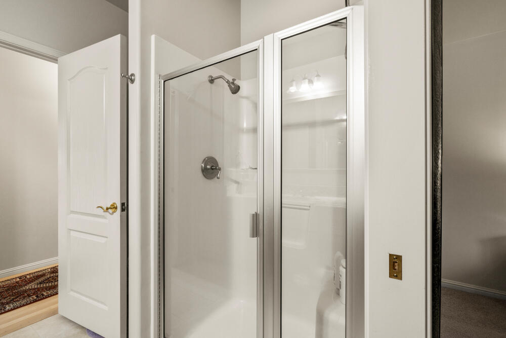 11629 Merganser Road Klamath Falls, OR 97601 - Photo 21 of 50 a bathroom with a glass shower door