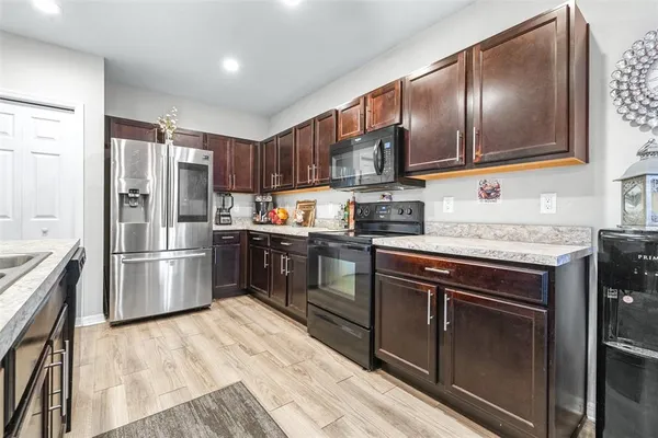 a kitchen with granite countertop stainless steel appliances and wooden cabinets