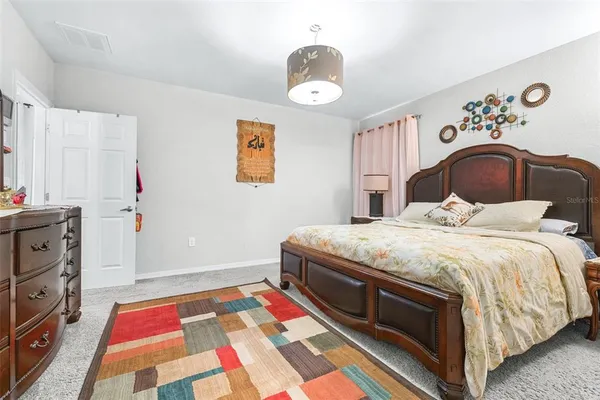 a bedroom with a bed and a chandelier