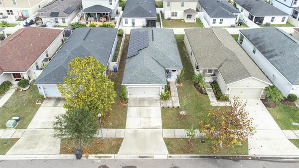 an aerial view of residential houses with outdoor space and street view