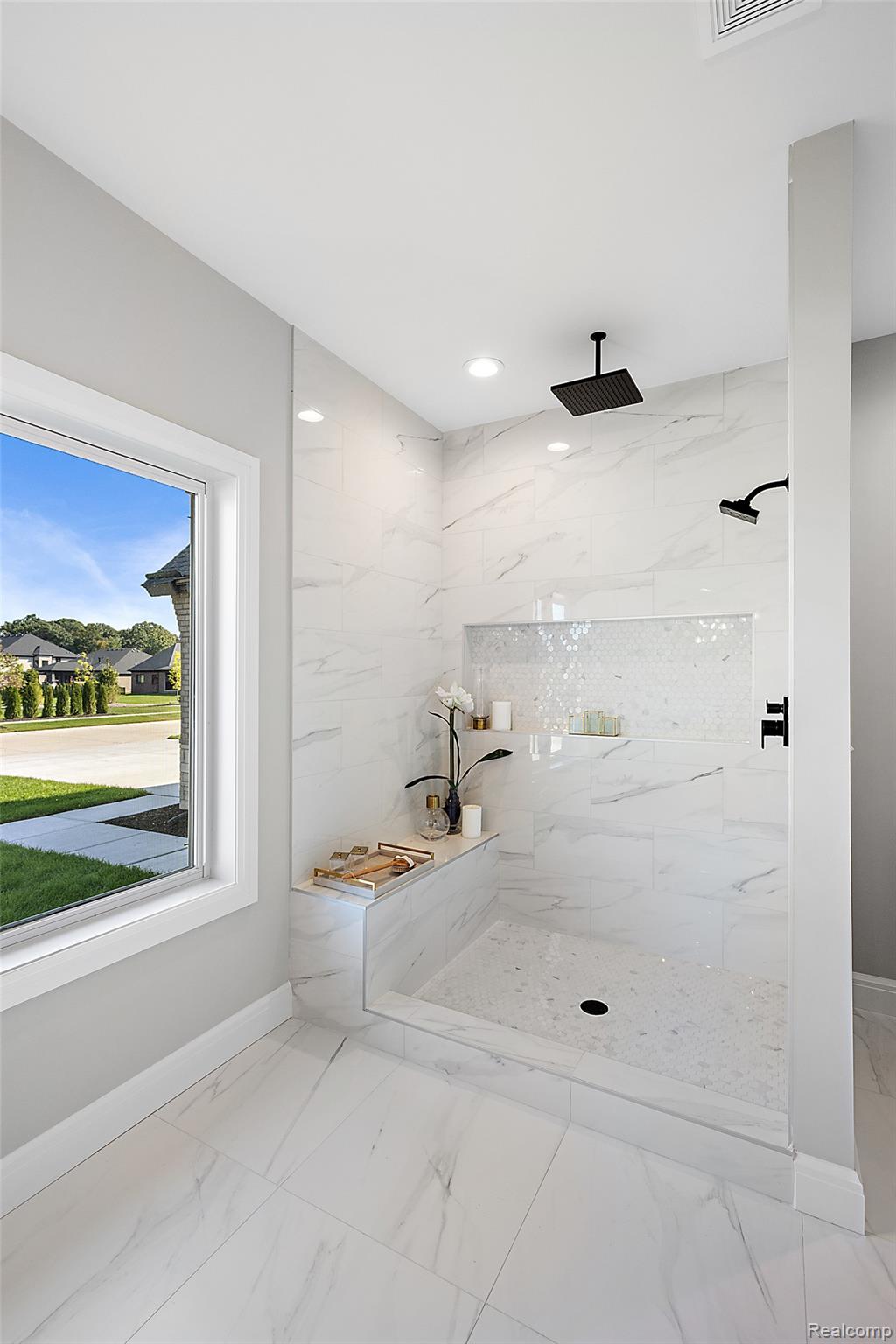 8267 Sandi Lane Romeo, MI 48065 - Photo 29 of 46 Walk-in shower with a built-in bench, rain shower head, hand-held shower fixture, and recessed shelf