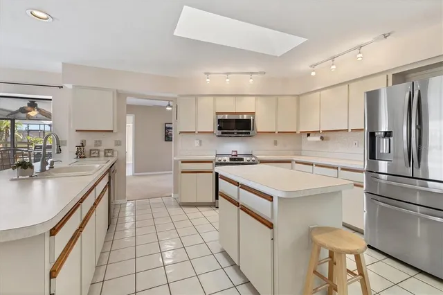 a view of a patio with table and chairs under an umbrella