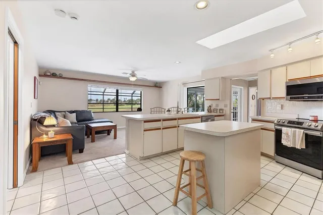 an aerial view of residential houses with outdoor space and trees
