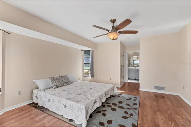 a green field with trees in the background