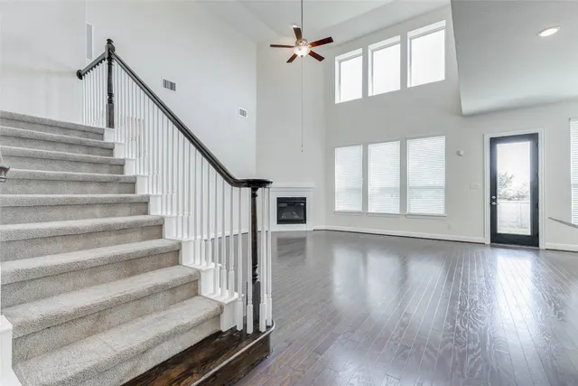 a view of staircase with white walls and windows