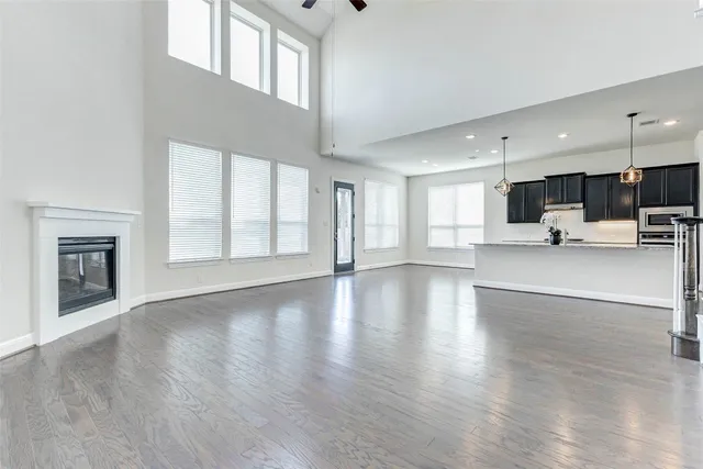 a view of empty room with wooden floor and fireplace