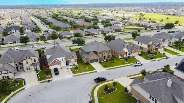 an aerial view of residential houses with outdoor space