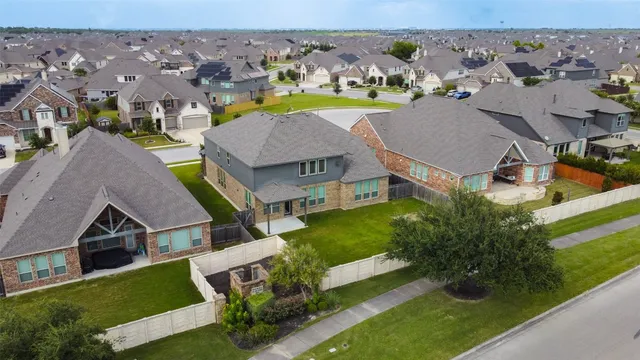 an aerial view of multiple houses with yard