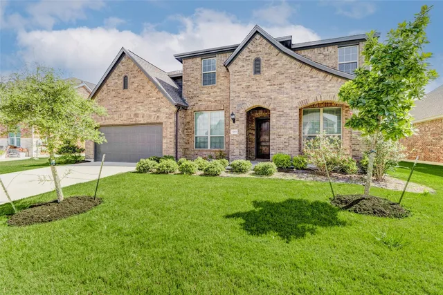 a front view of house with a garden