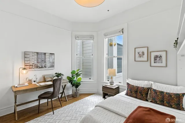a bedroom with furniture and a potted plant