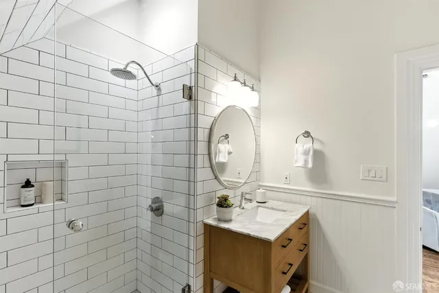 a bathroom with a sink mirror and vanity