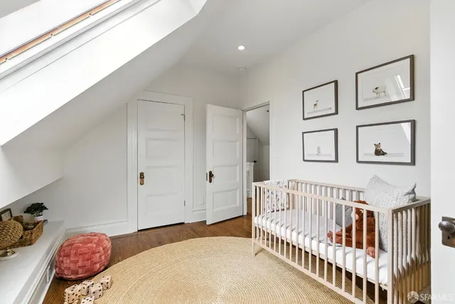 a bedroom with furniture and baby crib