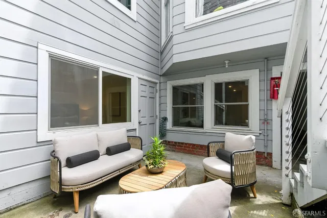 a view of a patio with couches and a potted plant on a table