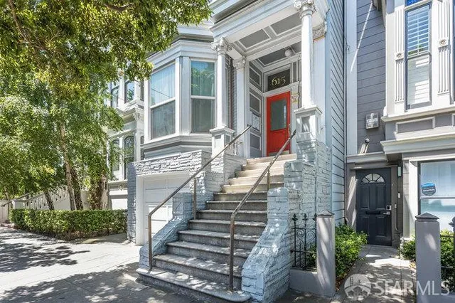 a view of an entrance of building with a small yard