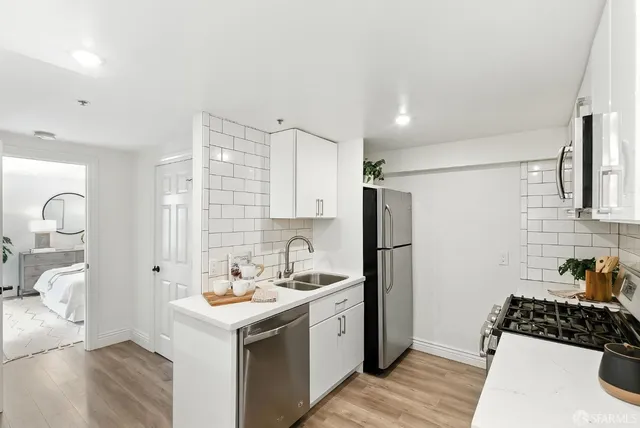 a kitchen with a sink stove and refrigerator