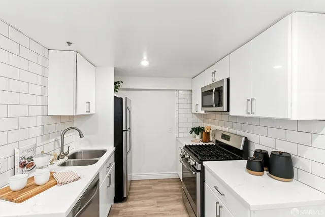 a kitchen that has a sink and a stove