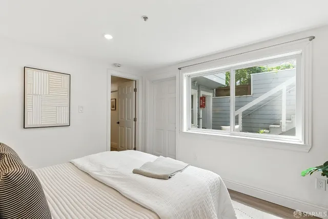 a bedroom with a bed and a window