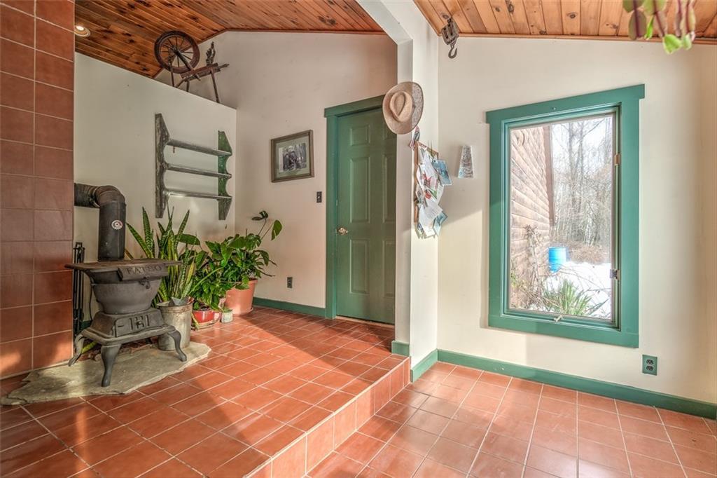 576 Brighton Hill Road Minot, ME 04258 - Photo 27 of 34 Sunroom room. (wood stove here does...