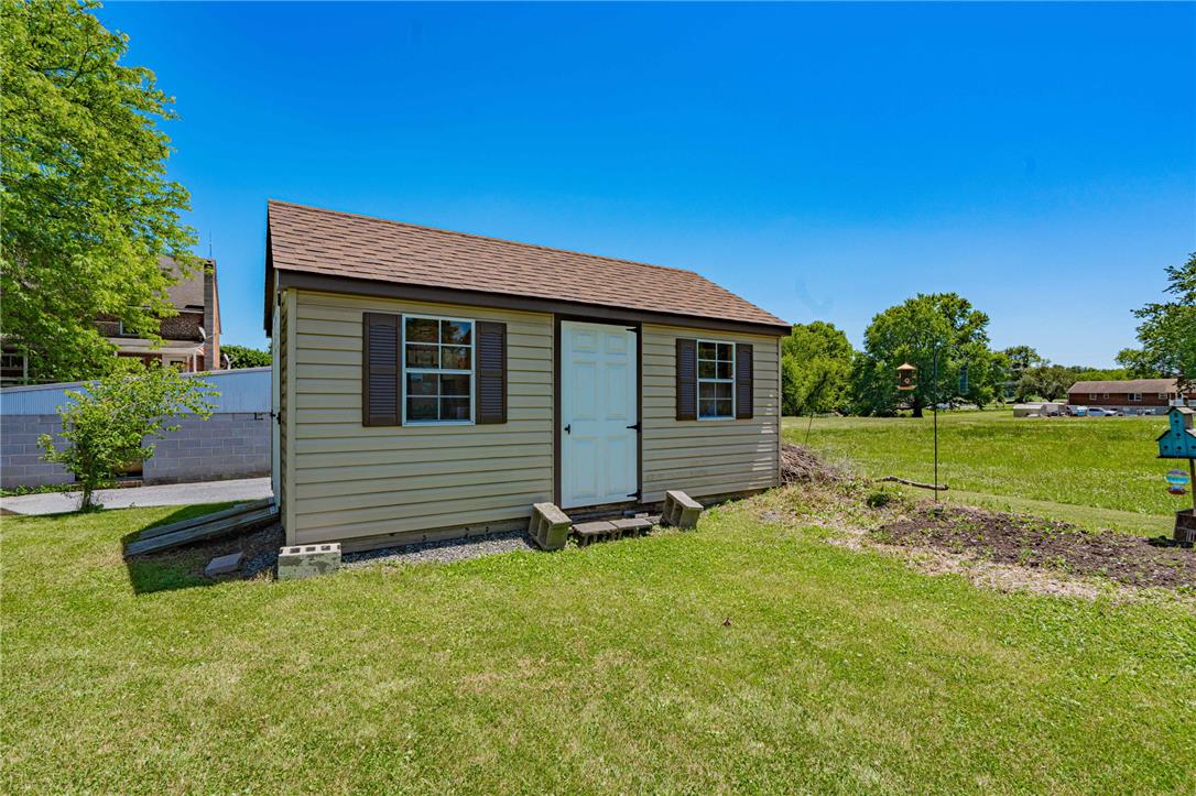 652 Old State Road Oley, PA 19547 - Photo 47 of 54 A quaint shed offers practical storage solutions amidst a verdant lawn.
