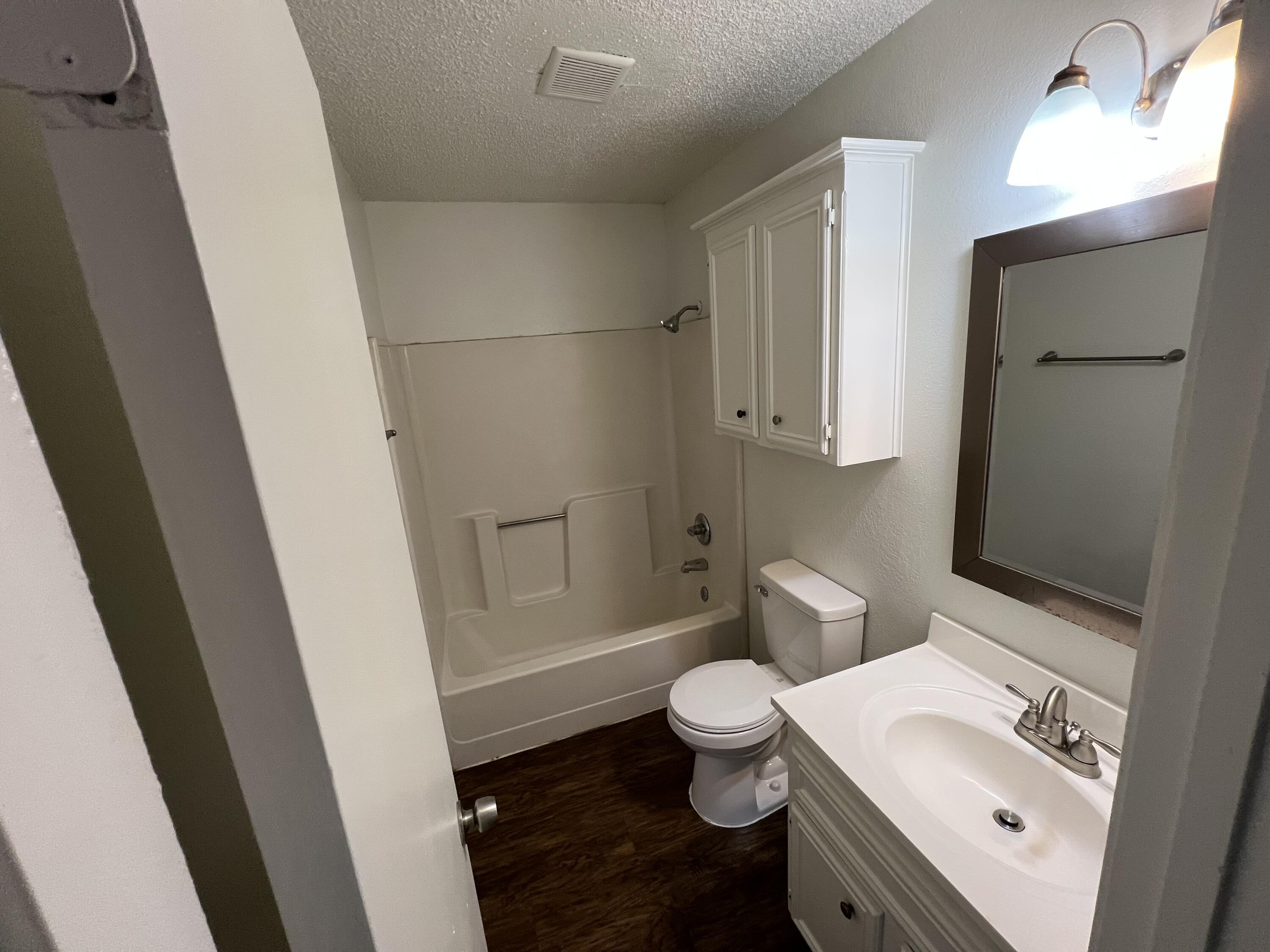 2409 88th Street Lubbock, TX 79423 - Photo 6 of 7 a bathroom with a sink toilet and shower