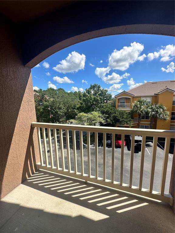8849 Villa View Circle, Unit 306 Orlando, FL 32821 - Photo 15 of 15 a view of balcony with wooden floor & fence