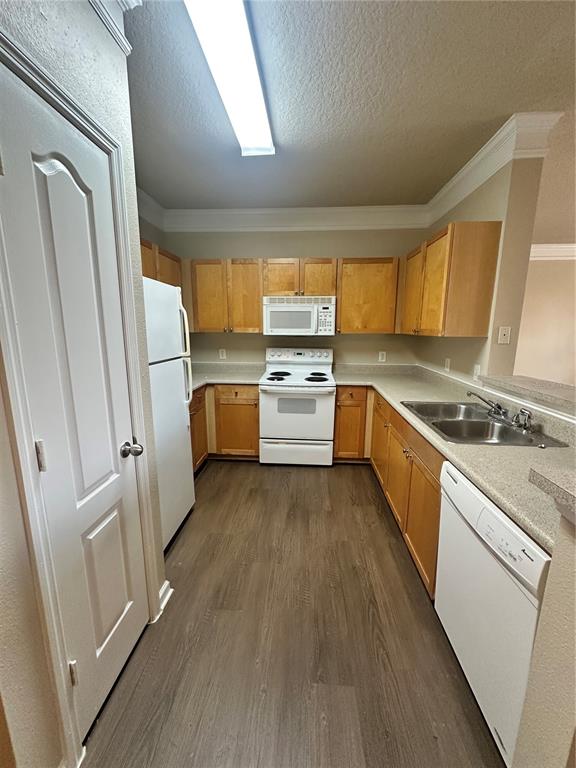 8849 Villa View Circle, Unit 306 Orlando, FL 32821 - Photo 4 of 15 a kitchen with a refrigerator a sink and a stove