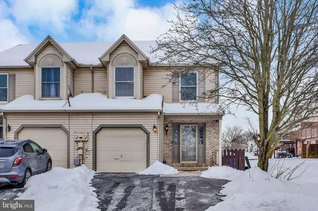 a front view of a house with parking space