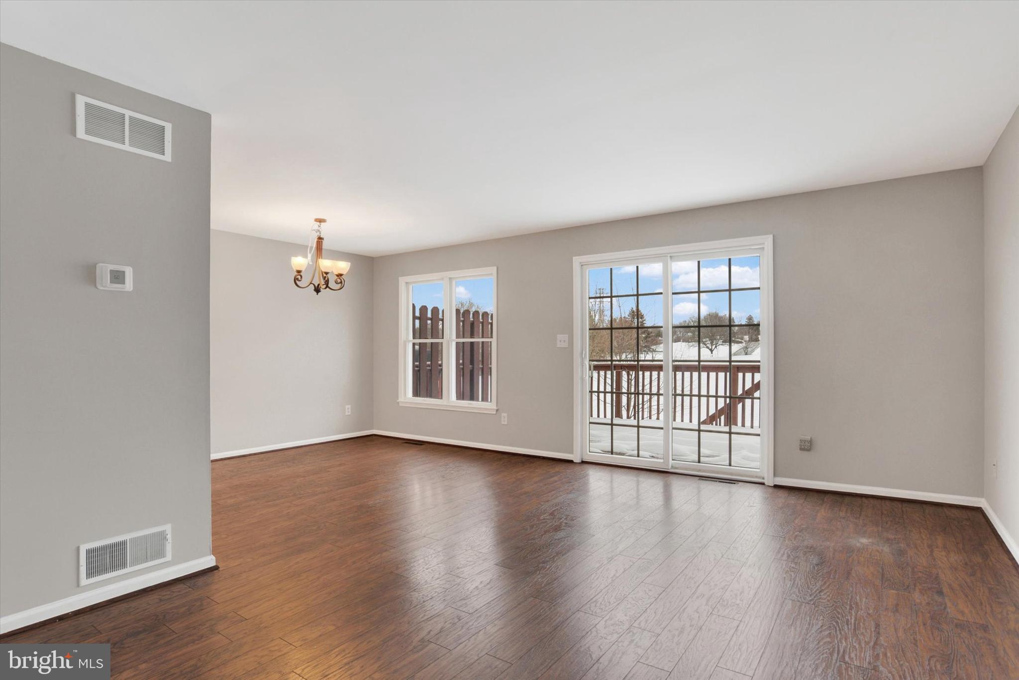 1041 Memory Lane Harrisburg, PA 17111 - Photo 11 of 31 an empty room with wooden floor and windows