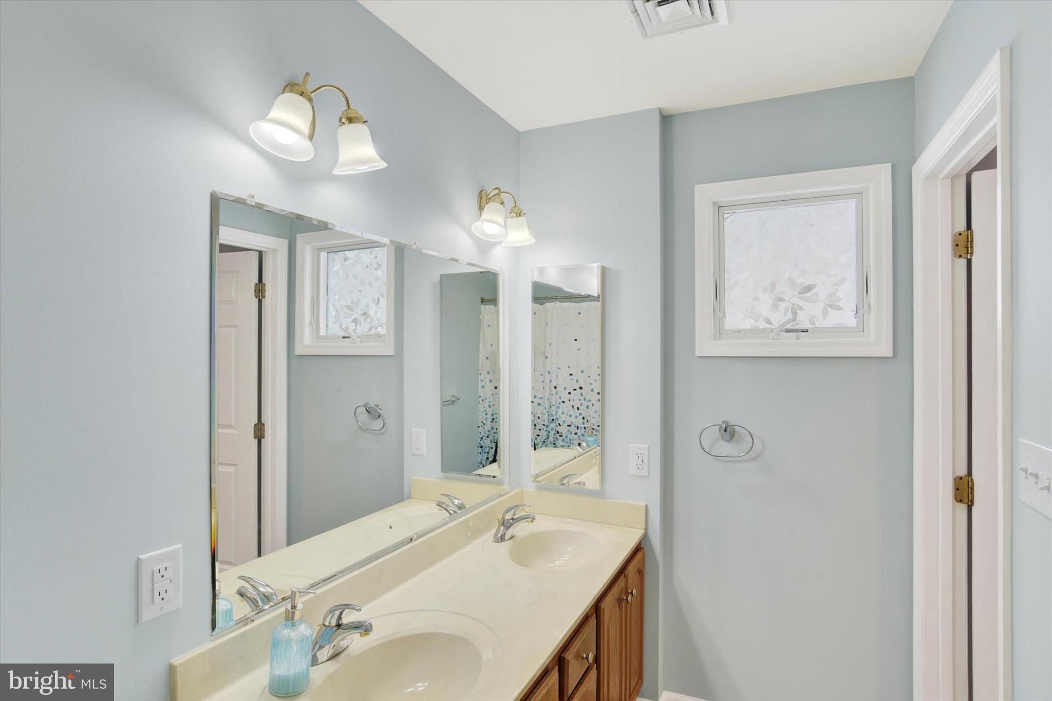 1041 Memory Lane Harrisburg, PA 17111 - Photo 16 of 31 a bathroom with a double vanity sink and a mirror
