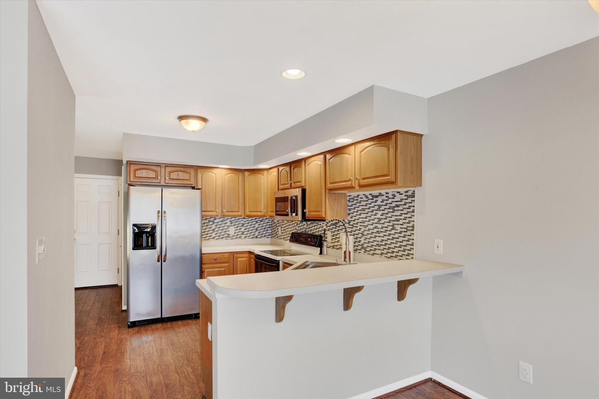 1041 Memory Lane Harrisburg, PA 17111 - Photo 7 of 31 a kitchen with stainless steel appliances granite countertop a sink and wooden cabinets
