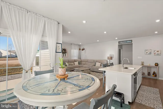 a living room with furniture and flowers